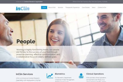 Foster City Website Design 7 Three people smiling and talking in a business meeting around a white table.